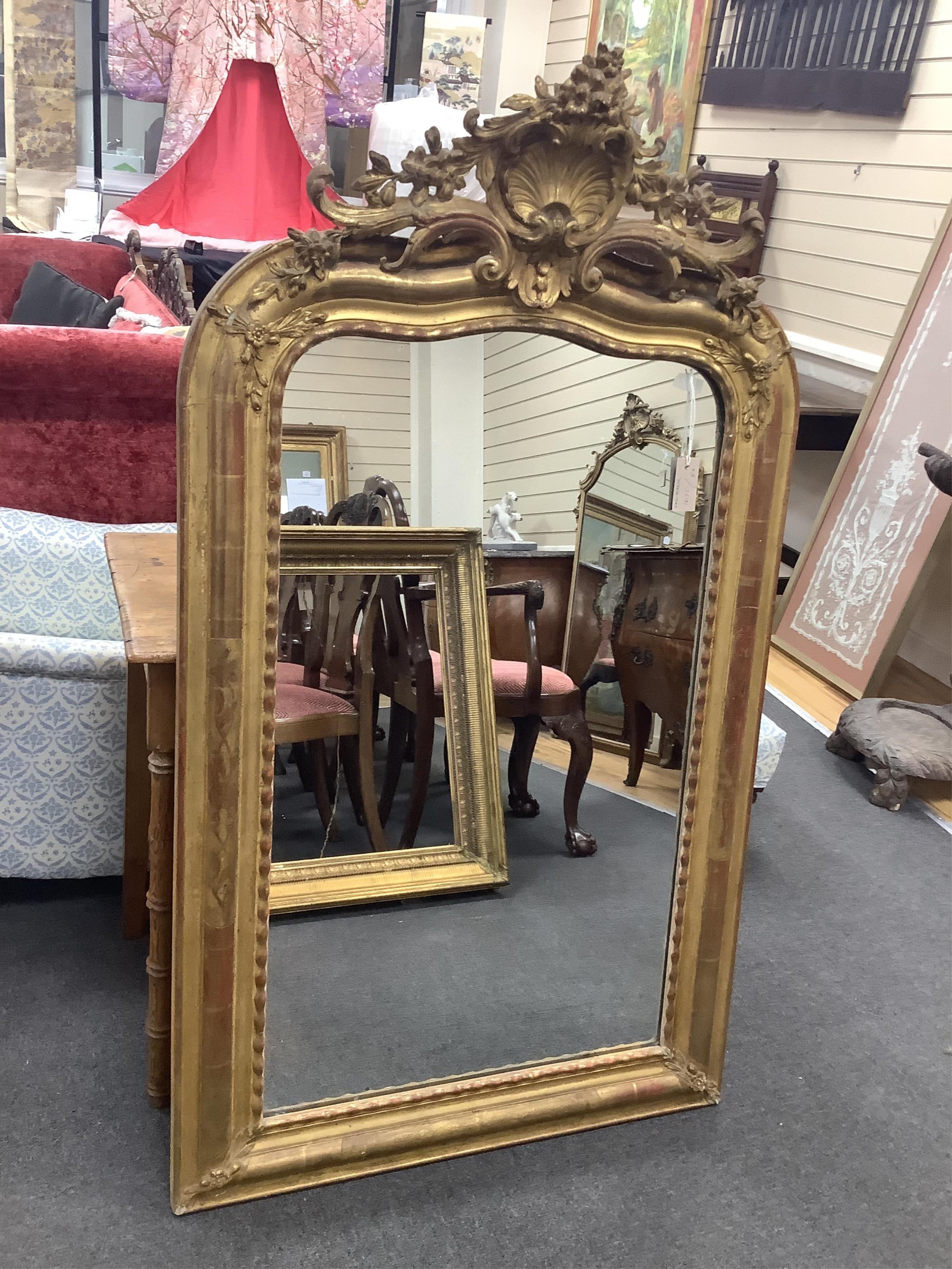 A French Louis XV style oval carved gilt wall mirror, width 80cm, height 140cm. Condition - fair